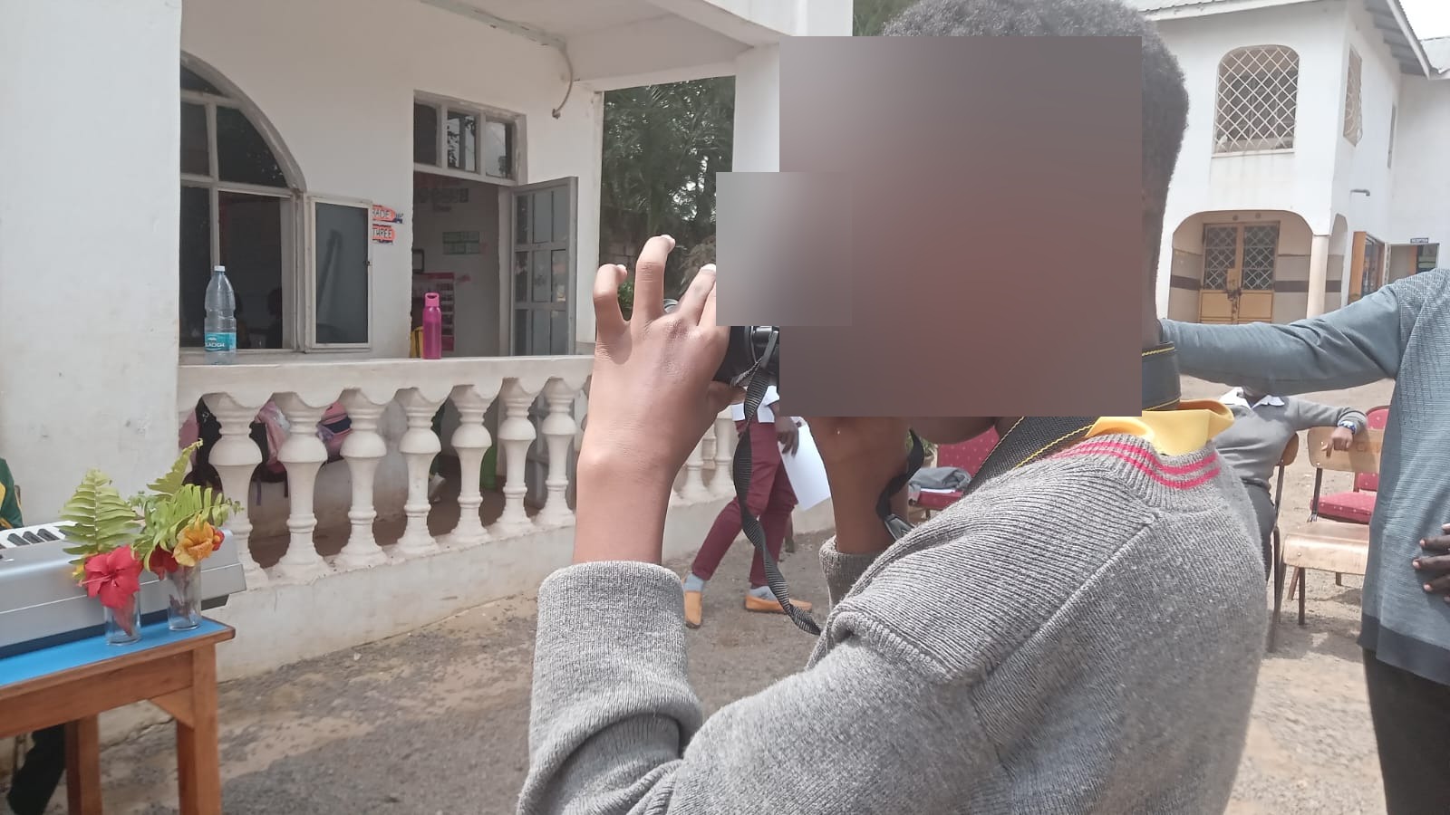 A learner practising photography during a school activity